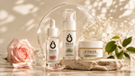 Three skincare products from This is it. are arranged on a stone slab with a pink rose, baby's breath flowers, and green leaves against a warm beige background with leaf shadows.
